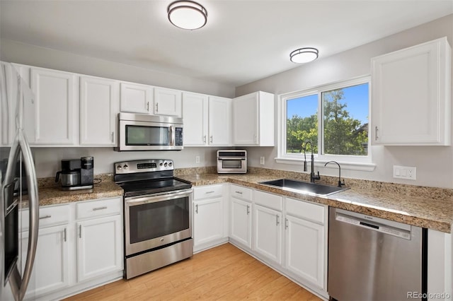 104 Willowick Cir, Highlands Ranch, CO 80129 - kitchen featuring stainless steel appliances, white cabinets, and light wood-type flooring