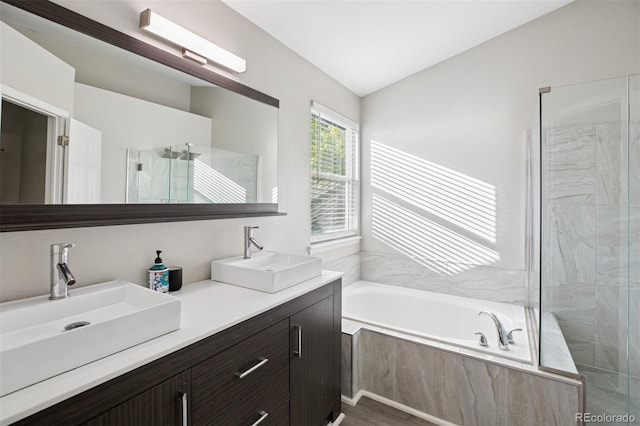 104 Willowick Cir, Highlands Ranch, CO 80129 - bathroom featuring a bath, double vanity, walk in shower, and vaulted ceiling