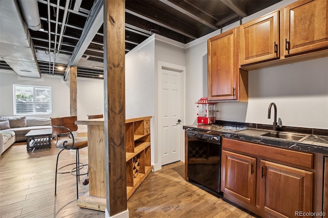 104 Willowick Cir, Highlands Ranch, CO 80129 - kitchen with black dishwasher, open floor plan, light wood-type flooring, and brown cabinetry