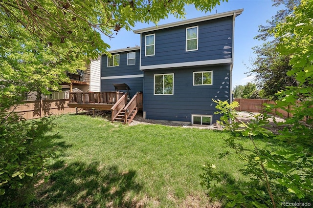 104 Willowick Cir, Highlands Ranch, CO 80129 - back of property with a fenced backyard, a deck, and stairway