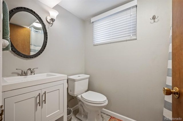 986 S Jersey St, Denver, CO 80224 - bathroom featuring toilet, baseboards, and vanity