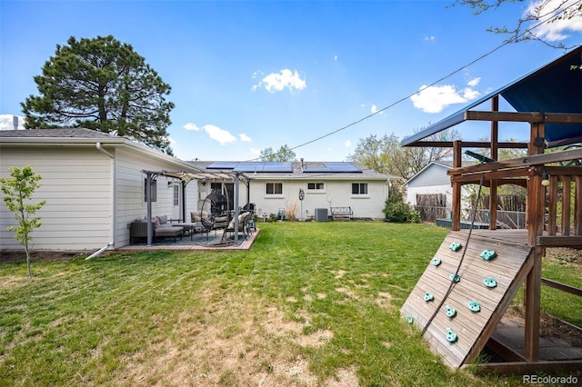 986 S Jersey St, Denver, CO 80224 - back of property featuring solar panels, a pergola, a patio area, and an outdoor hangout area