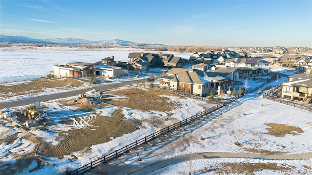 snowy aerial view featuring a mountain view