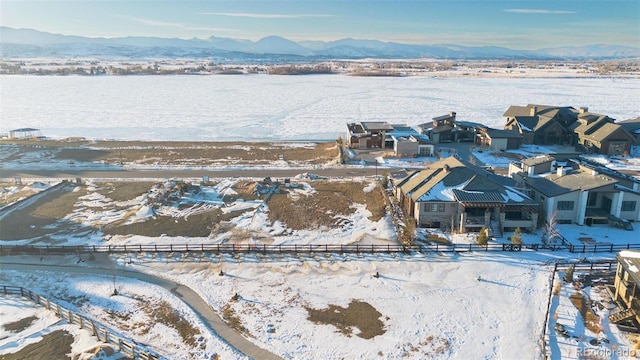 snowy aerial view featuring a mountain view