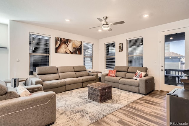 living room with hardwood / wood-style flooring and ceiling fan