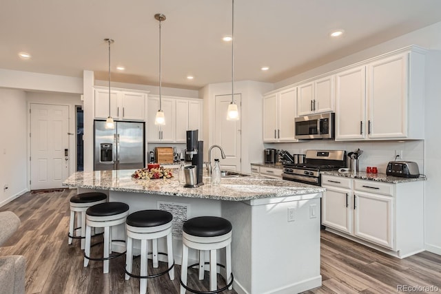 kitchen featuring white cabinetry, sink, an island with sink, and appliances with stainless steel finishes