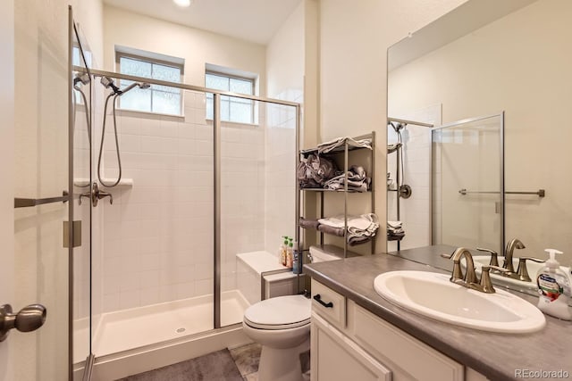 bathroom with vanity, toilet, and walk in shower