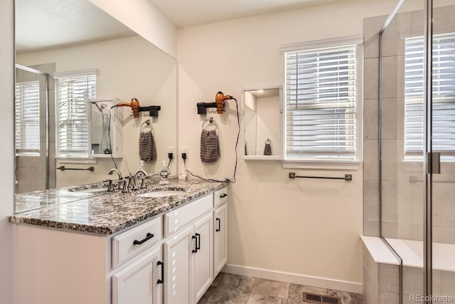 bathroom with vanity and an enclosed shower