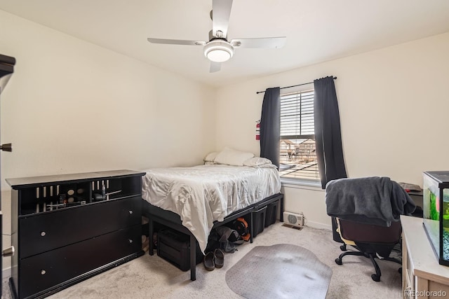 bedroom with light carpet and ceiling fan