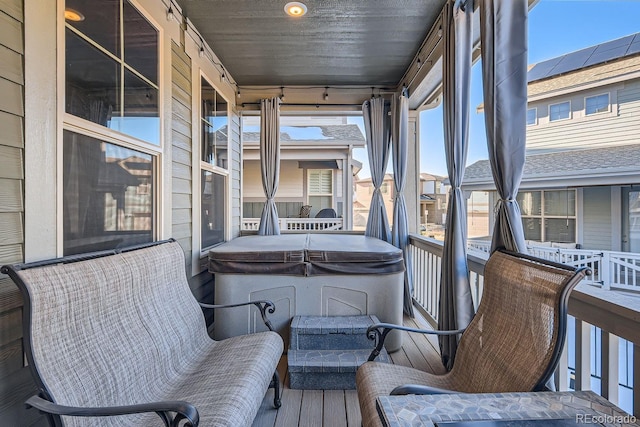 sunroom / solarium featuring a hot tub