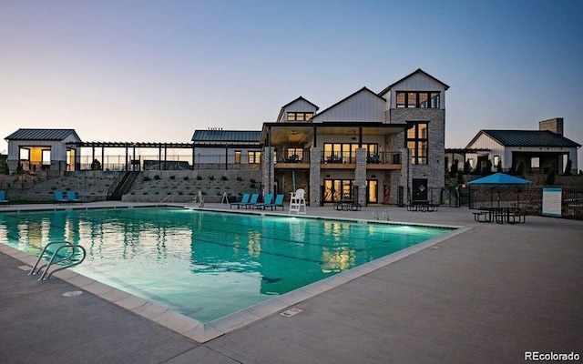 pool at dusk with a patio