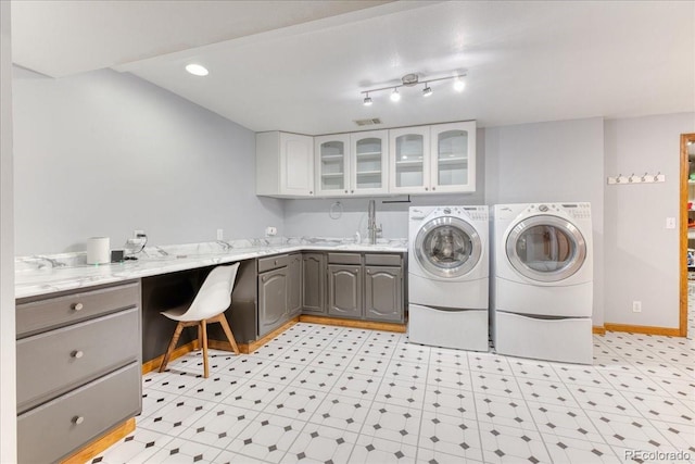 clothes washing area with washing machine and dryer, cabinet space, baseboards, and recessed lighting