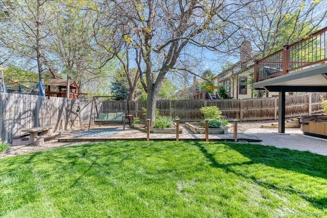 view of yard with a hot tub, a garden, and a patio area