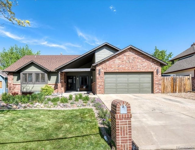 view of front of property featuring driveway, brick siding, and a garage