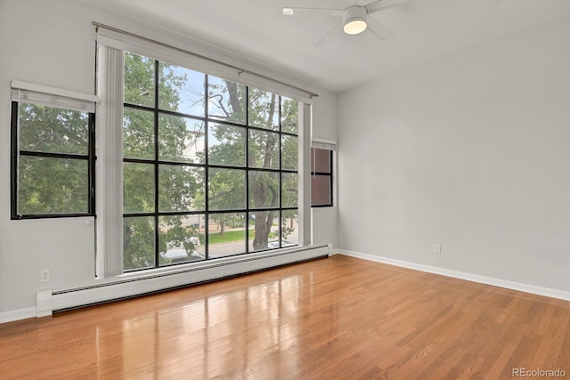 505 E 24th St Unit 204, Denver, CO 80205 - empty room with a baseboard radiator, a ceiling fan, and wood finished floors