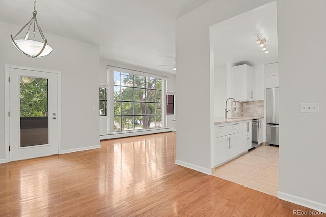 505 E 24th St Unit 204, Denver, CO 80205 - entryway with a baseboard radiator, light wood-type flooring, and a ceiling fan