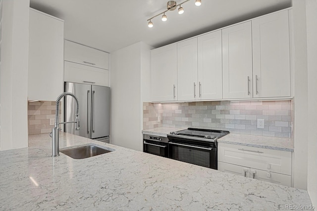 505 E 24th St Unit 204, Denver, CO 80205 - kitchen featuring black electric range, high end refrigerator, tasteful backsplash, and light stone counters