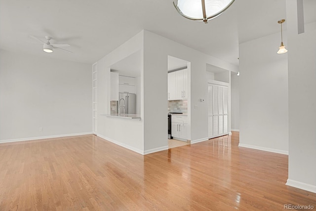 505 E 24th St Unit 204, Denver, CO 80205 - unfurnished living room with a ceiling fan and light wood-style floors