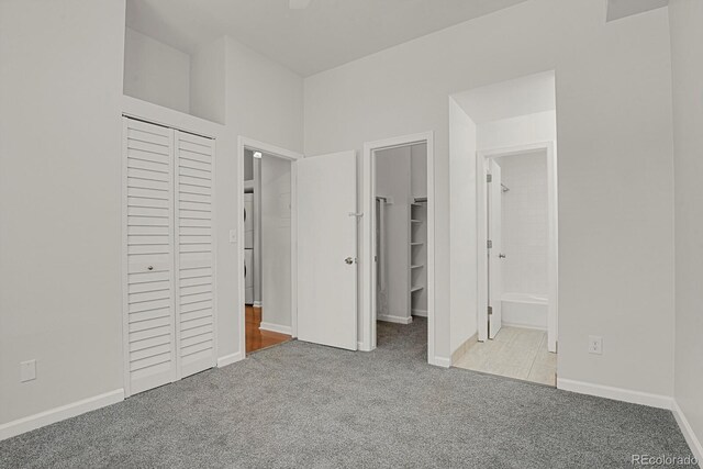 505 E 24th St Unit 204, Denver, CO 80205 - unfurnished bedroom featuring carpet, connected bathroom, a closet, a spacious closet, and fridge
