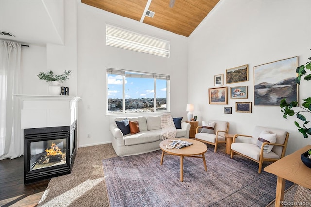 living room with high vaulted ceiling, wood ceiling, and a multi sided fireplace