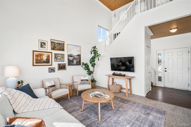 carpeted living room with high vaulted ceiling, a healthy amount of sunlight, and wooden ceiling