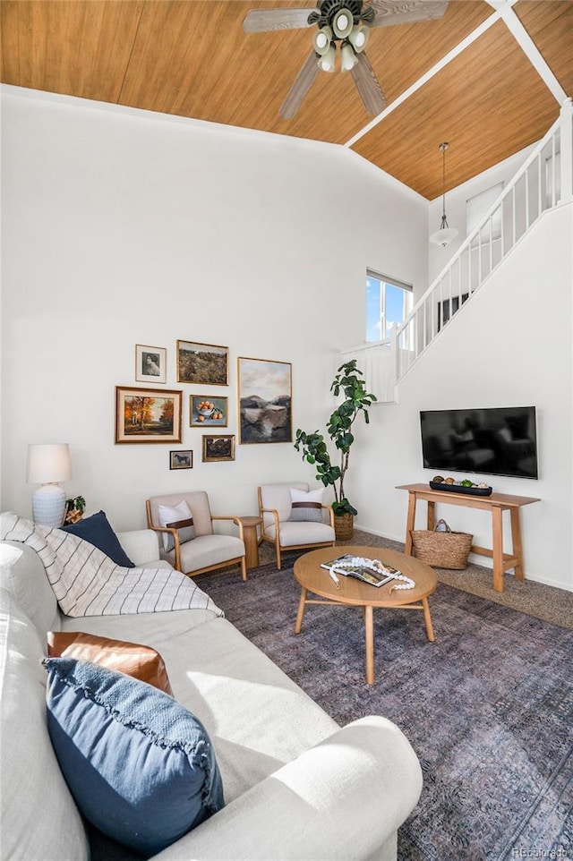 living room with ceiling fan, wooden ceiling, carpet, and high vaulted ceiling