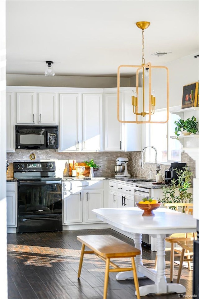 kitchen featuring pendant lighting, black appliances, decorative backsplash, sink, and white cabinets