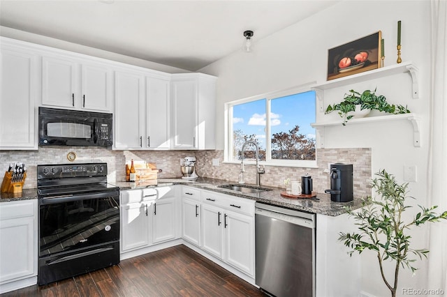 kitchen featuring sink, white cabinetry, black appliances, and dark stone counters