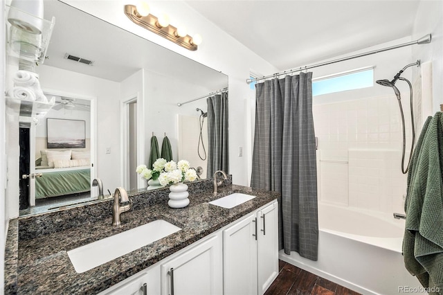 bathroom featuring ceiling fan, hardwood / wood-style floors, vanity, and shower / bath combo with shower curtain