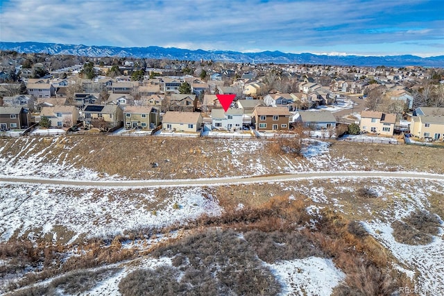 snowy aerial view featuring a mountain view