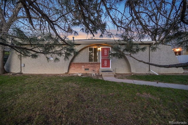 1280 Sable Blvd, Aurora, CO 80011 - view of front of property with brick siding, a front yard, and stucco siding