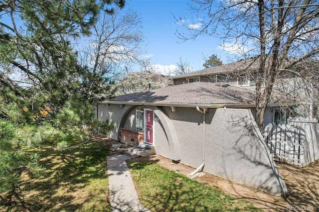 1280 Sable Blvd, Aurora, CO 80011 - view of property exterior featuring a shingled roof and stucco siding