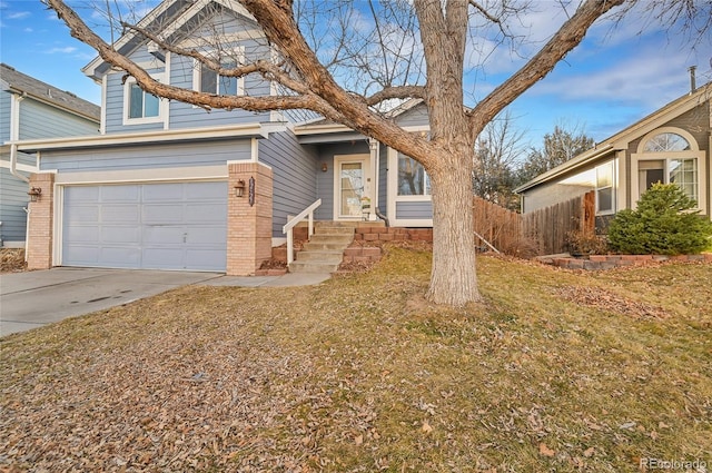 view of front of property with a garage, brick siding, driveway, and fence