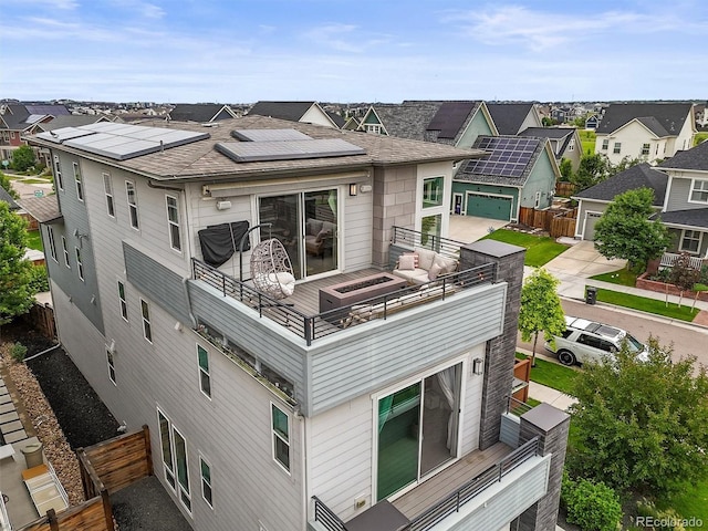 9391 E 59th N Pl, Denver, CO 80238 - back of property with a residential view, a balcony, and roof mounted solar panels