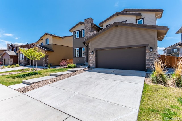 view of front of home featuring a garage and a front lawn