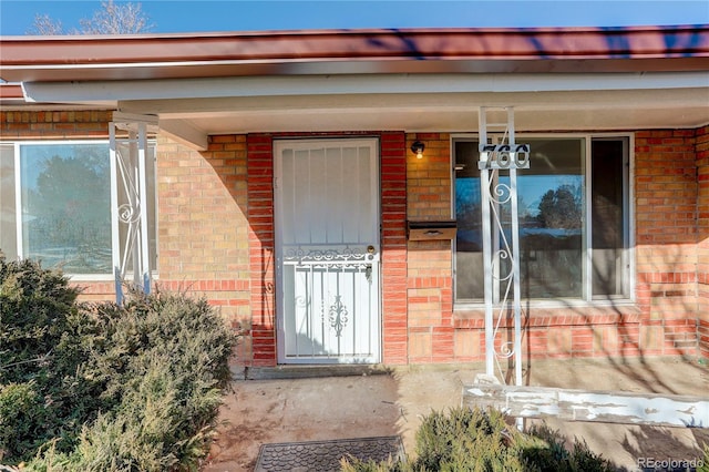 property entrance featuring brick siding