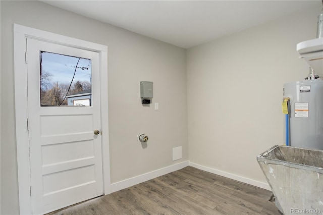 entryway featuring water heater, wood finished floors, and baseboards