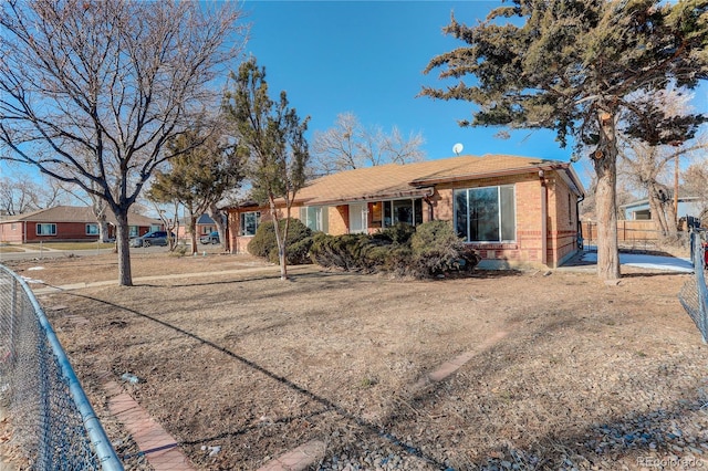 ranch-style home with brick siding and fence