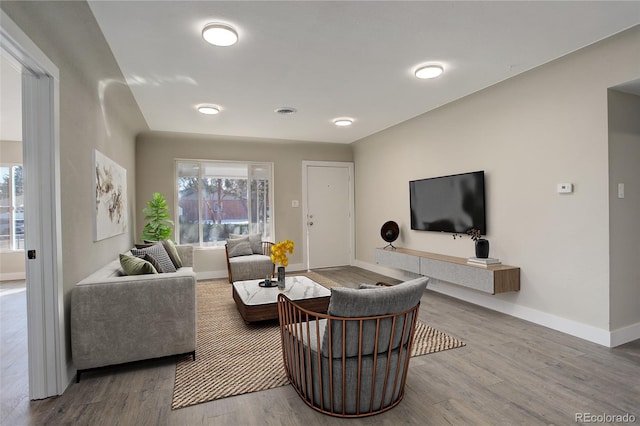 living room with baseboards and wood finished floors