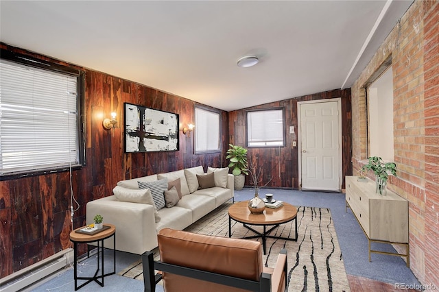 carpeted living area featuring lofted ceiling, baseboard heating, and wooden walls