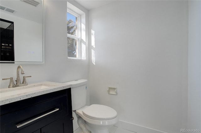 half bath featuring toilet, visible vents, and vanity