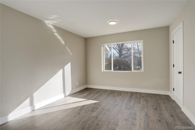 interior space with baseboards and wood finished floors