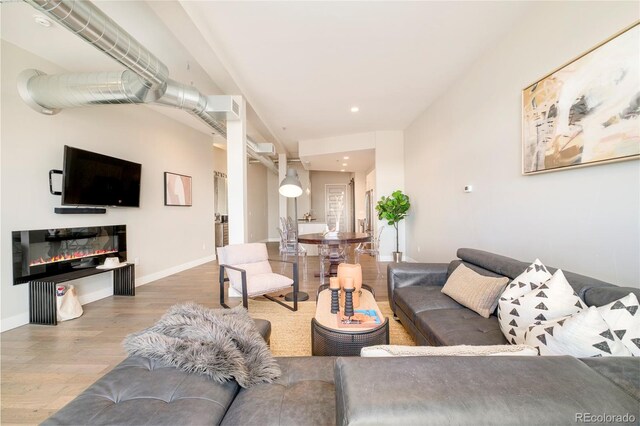 3198 Blake St Unit 502, Denver, CO 80205 - living area with wood finished floors and recessed lighting