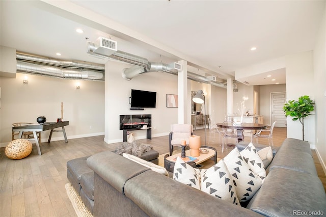 3198 Blake St Unit 502, Denver, CO 80205 - living room featuring wood finished floors and recessed lighting
