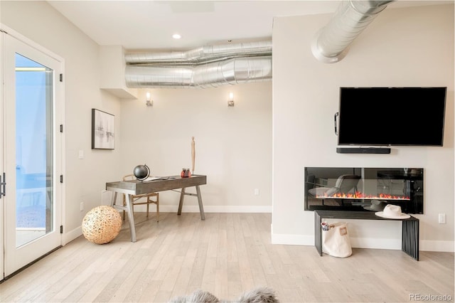 3198 Blake St Unit 502, Denver, CO 80205 - home office featuring wood finished floors, plenty of natural light, a glass covered fireplace, and recessed lighting