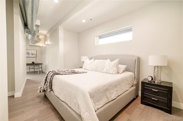 3198 Blake St Unit 502, Denver, CO 80205 - bedroom with wood finished floors and recessed lighting