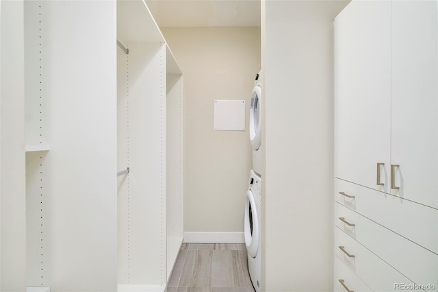 3198 Blake St Unit 502, Denver, CO 80205 - laundry room featuring estacked washer and dryer and baseboards