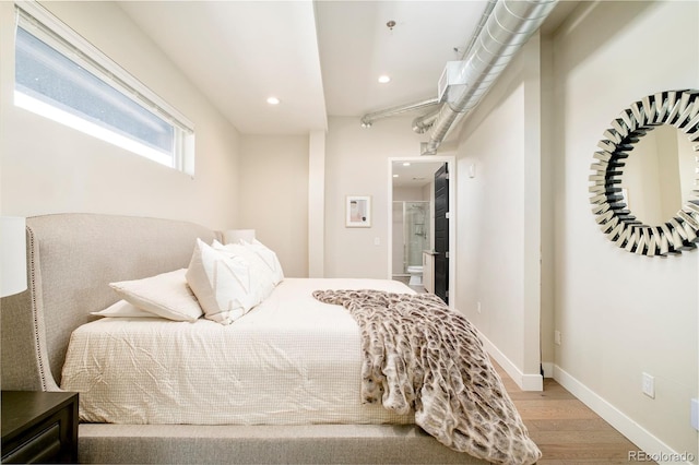 3198 Blake St Unit 502, Denver, CO 80205 - bedroom featuring wood finished floors, recessed lighting, and ensuite bathroom