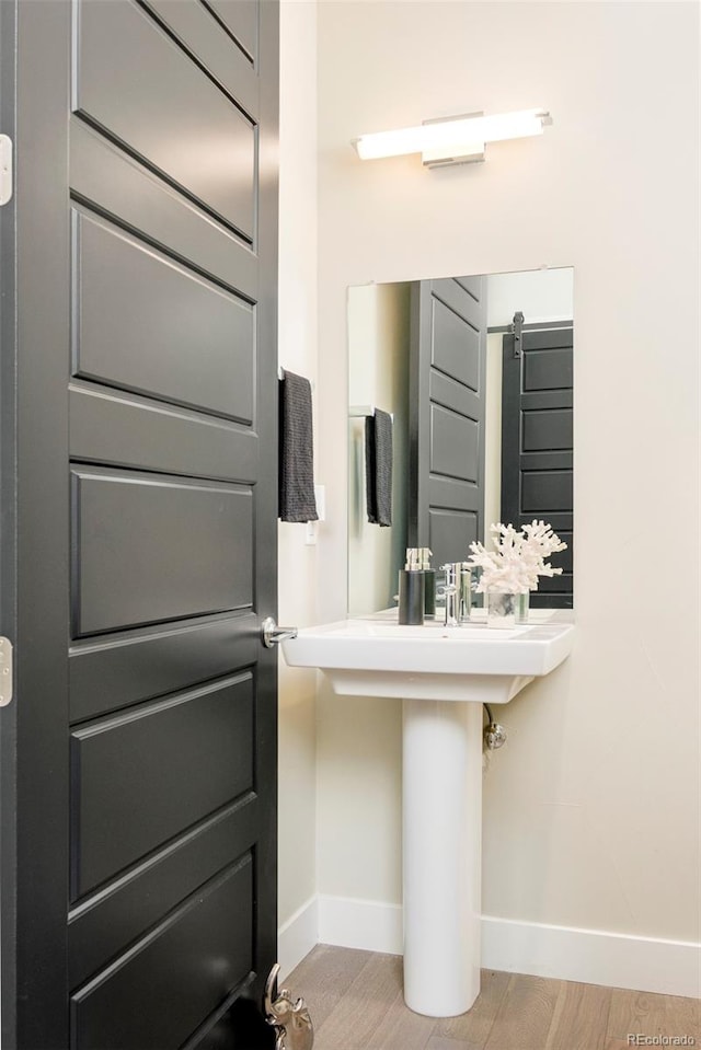 3198 Blake St Unit 502, Denver, CO 80205 - bathroom with baseboards and wood finished floors