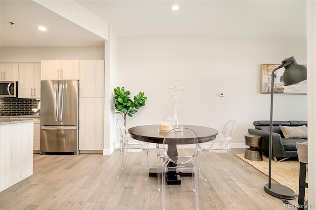 3198 Blake St Unit 502, Denver, CO 80205 - dining room featuring light wood-type flooring and recessed lighting